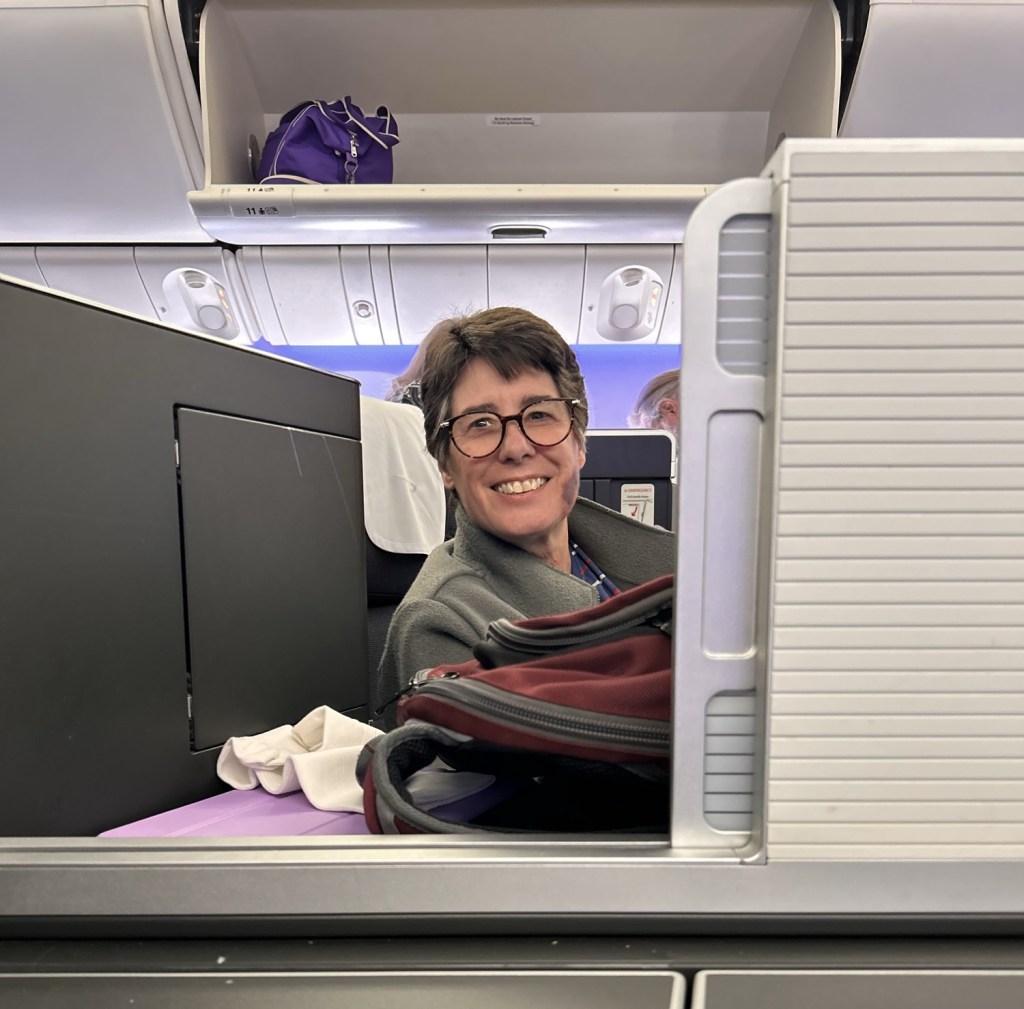 Photo of Beloved in the other center seat, a good three feet away from me.  We have the sliding divider open, but talking required raising your voice.